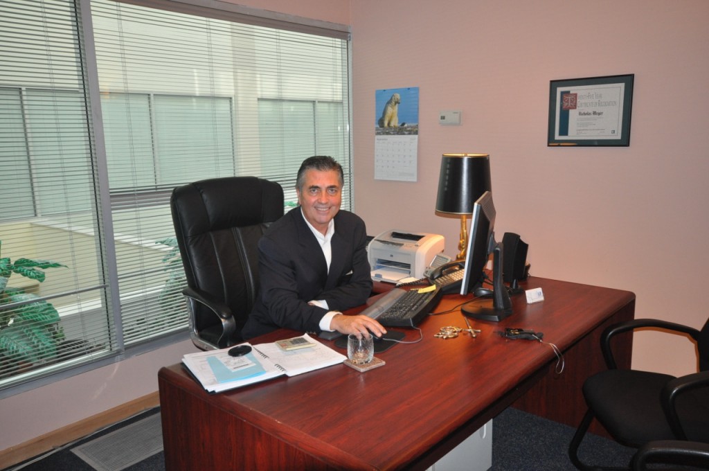 Nic Meyer at his desk in his office at Downtown Suites in Vancouver BC
